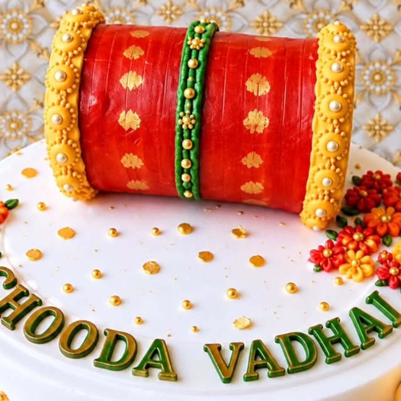 Traditional red and gold Chooda Vadhai ceremony cake